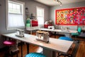 sewing room, with sewing machines in use and fabrics in vibrant colors