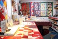 sewing room, with sewing machines in use and fabrics in vibrant colors