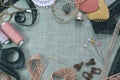 Sewing scene table flat lay composition. Threads, lace, pins, scissors, tape, reel, cloth. Pastel colors linen fabric
