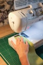 Sewing, stitching and overlocking on a machine at home Royalty Free Stock Photo