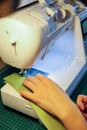 Sewing, stitching and overlocking on a machine at home Royalty Free Stock Photo