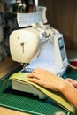 Sewing, stitching and overlocking on a machine at home Royalty Free Stock Photo