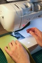 Sewing, stitching and overlocking on a machine at home Royalty Free Stock Photo