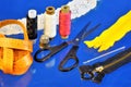 Sewing tailor - a set of threads, scissors, needles, thimble, on a creative blue background, centimeter for pattern. A set of Royalty Free Stock Photo