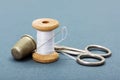 Sewing thread, needle, thimble and scissors Royalty Free Stock Photo