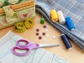 Sewing thread spools, measuring tape, textile, buttons and scissors. Sewing supplies, and accessories for needlework, stitching Royalty Free Stock Photo