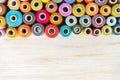 Multicolor sewing threads on white wooden background with copy space Royalty Free Stock Photo