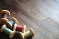 Sewing thread on a wooden background. Set of threads on bobbins Royalty Free Stock Photo