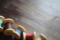 Sewing thread on a wooden background. Set of threads on bobbins Royalty Free Stock Photo