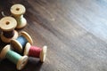 Sewing thread on a wooden background. Set of threads on bobbins Royalty Free Stock Photo