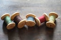 Sewing thread on a wooden background. Set of threads on bobbins Royalty Free Stock Photo