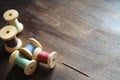 Sewing thread on a wooden background. Set of threads on bobbins Royalty Free Stock Photo