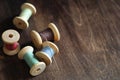 Sewing thread on a wooden background. Set of threads on bobbins Royalty Free Stock Photo