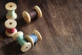 Sewing thread on a wooden background. Set of threads on bobbins Royalty Free Stock Photo