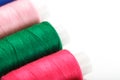 Sewing threads of different colors on reels on a white background. Free space, close-up. Isolate Royalty Free Stock Photo