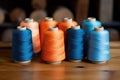 Sewing threads in different colors on wooden table