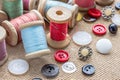 Sewing tools many different colorful thread, needle, many different buttons on wooden background. Royalty Free Stock Photo