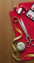 Sewing tools on red fabric background Royalty Free Stock Photo