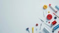 Sewing tools such as needles, threads, and buttons scattered on a white surface with ample blank space, ideal for Royalty Free Stock Photo