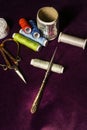 Sewing utensils placed on a deep purple Royalty Free Stock Photo