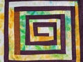 Sewn fragment of patchwork with yellow spiral