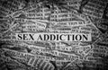 Sex Addiction. Torn pieces of paper with the words Sex Addiction