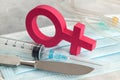 Sex-change operation. Change of female to male. Symbol of a woman and a scalpel with a syringe. Surgical Instruments Royalty Free Stock Photo