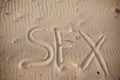 Sex handwritten in sand on a beach Royalty Free Stock Photo