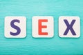 Sex word by letter blocks on blue wooden background. Top view. Copy space. Royalty Free Stock Photo