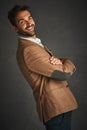 The sexiest man has a beard and smile. Studio shot of a handsome young man posing against a gray background. Royalty Free Stock Photo