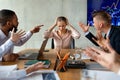 Angry Male Coworkers Shouting At Stressed Female Colleague At Meeting In Office Royalty Free Stock Photo