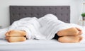 Sexual problems. Young guy and his girlfriend lying apart with their backs to each other in bed, closeup of feet Royalty Free Stock Photo
