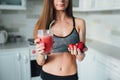 Sexual sports girl drinking a delicious smoothie with berries Royalty Free Stock Photo