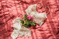 Sexual woman`s underwear on unmade bed.Openwork white cotton underpants on crumpled blanket. Red rose - concept gynecological