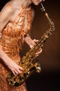 Sexual young woman posing with saxophone at studio Royalty Free Stock Photo