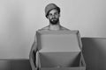 Sexuality and building concept: man standing naked with empty box Royalty Free Stock Photo