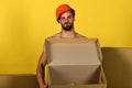 Sexuality and building concept: man standing naked with empty box Royalty Free Stock Photo