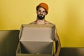 Sexuality and building concept: man standing naked with empty box Royalty Free Stock Photo