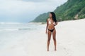 Sexy african american girl in swimwear resting on ocean beach, young black skinned woman Royalty Free Stock Photo