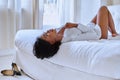 Afro girl lying on bed Royalty Free Stock Photo