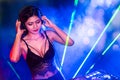 Sexy asian Dj mixing music in the club party. female disc jockey on turntable in nightclub enjoying mixing sound music.