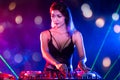 Sexy asian Dj mixing music in the club party. female disc jockey on turntable in nightclub enjoying mixing sound music. Royalty Free Stock Photo