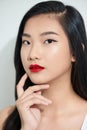 Sexy asian woman in satin dress with red lips touching neck isolated on white Royalty Free Stock Photo