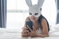woman with rabbit mask play smartphone Royalty Free Stock Photo