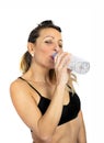 attractive woman in sport bra drinking water bottle at gym workout Royalty Free Stock Photo