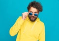 Sexy bearded man with curly hair and moustache looking over sunglasses Royalty Free Stock Photo