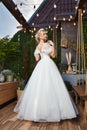 Sexy beautiful blonde woman pretty bride wedding big day marriage ceremony in summer garden wearing long silk and lace white dress Royalty Free Stock Photo