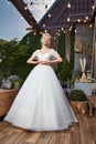 Sexy beautiful blonde woman pretty bride wedding big day marriage ceremony in summer garden wearing long silk and lace white dress Royalty Free Stock Photo