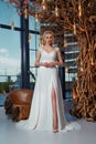 Sexy beautiful blonde woman pretty bride wedding big day marriage ceremony in summer garden wearing long silk and lace white dress Royalty Free Stock Photo