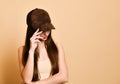 Sexy beautiful brunette woman in a brown suede baseball cap Royalty Free Stock Photo